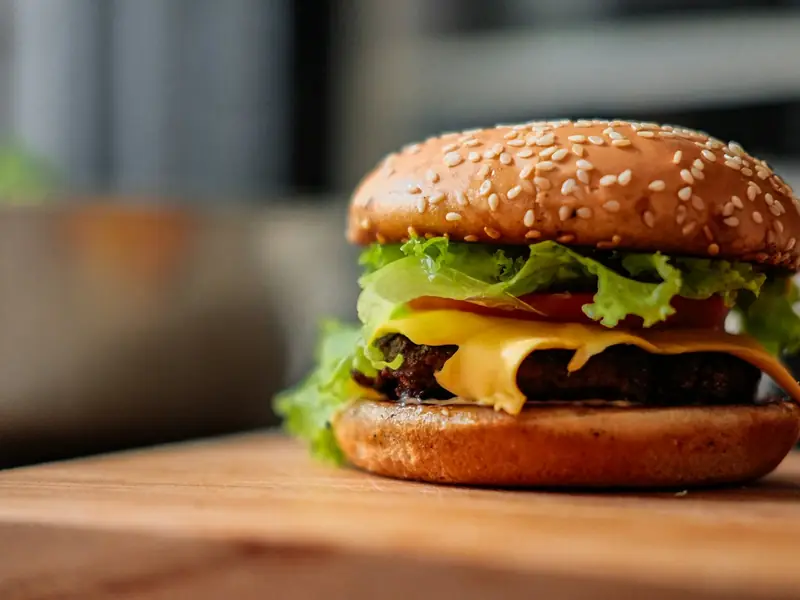 Cheeseburger with lettuce and tomato on a sesame bun
