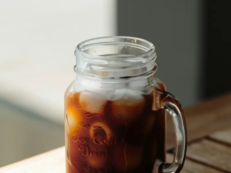 Cold brew coffee over ice in a mason jar mug